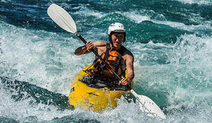 Alan Scandrett kayaking in white water rapids