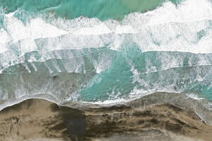 Aerial view of surf meeting the shoreline