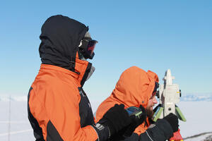 Two surveyors on the snow in Antarctica