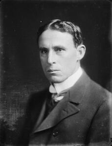 Portrait of a man with a serious expression and wearing a suit