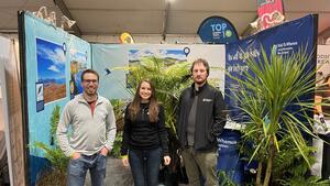3 people in front of the LINZ Fieldays stand