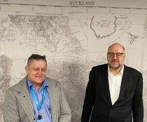 Mike Webster engagement lead James Mowat in front of a map of Auckland 