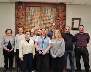 A group of 10 people smiling in an office