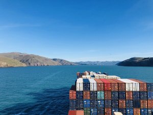 Container ship crossing a harbour