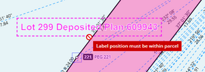 image of a parcel appellation label being moved. The mouse cursor is outside the parcel boundary, and a red warning has popped up reading: "Label position must be within parcel".