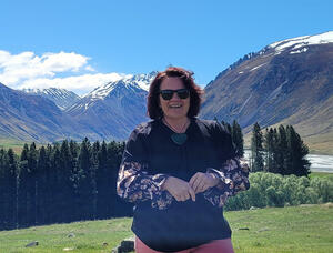 Sonya Wikitera posing in front of mountain range