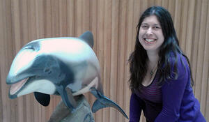 Geospatial student Tania Te Hira with a model of a dolphin