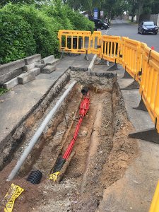 Roadworks that have exposed a utility pipe
